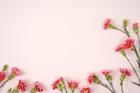 Design concept of Mother's day holiday greeting with carnation bouquet on pink table background