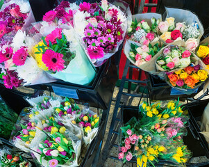 Bunches of flowers for sale in a supermarket.