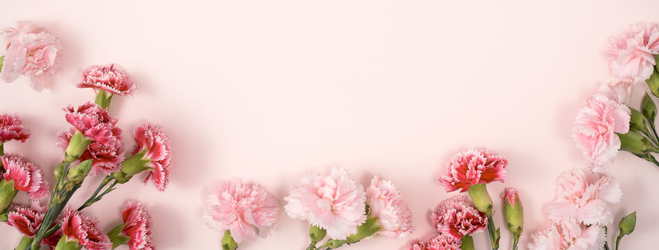 Design concept of Mother's day holiday greeting with carnation bouquet on pink table background