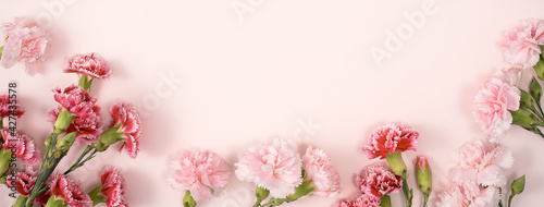 Design concept of Mother's day holiday greeting with carnation bouquet on pink table background