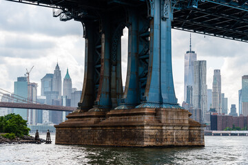 Detail of Pillar of Manhattan Bridge against cityscape of New York City. Steel Abutment With Bolt...