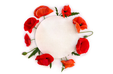 Flowers red poppies ( corn poppy, corn rose, field poppy ) with white circle paper card note with space for text on a white background. Top view, flat lay