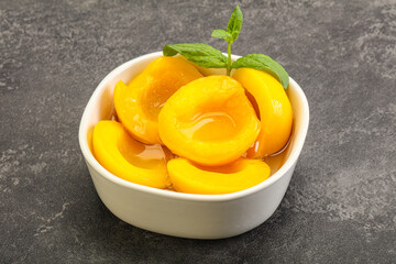 Sweet ripe canned peaches with mint