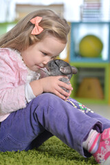 Cute little girl playing with chinchilla