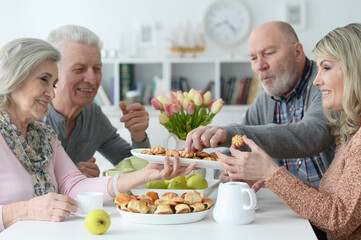 two  Senior couples drinking tea