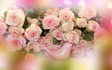 Pink mother's day still life with roses and a little bird. Abstract floral background with tender bokeh.