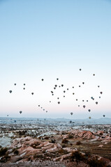 TURKEY, CAPPADOCIA, GOREME:  Aerial scenic view of hot air balloons flying over valleys of Göreme National Park