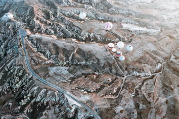 TURKEY, CAPPADOCIA, GOREME:  Aerial scenic view of hot air balloons flying over valleys of Göreme National Park