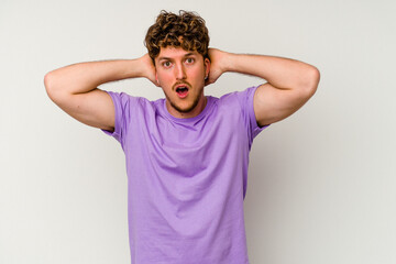 Young caucasian man isolated on white background screaming, very excited, passionate, satisfied with something.