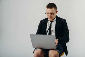 Pleasant positive business man using laptop