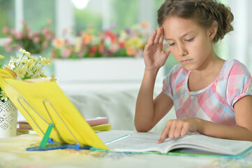little cute girl doing homework  at home