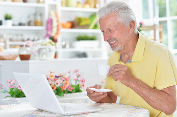  senior man using laptop