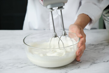 pastry chef preparing mixing meringue for cake and bakery. - 427443153