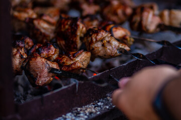 Grilled meat on skewers. Fresh shish kebab on skewers is fried on the grill. Cooking.