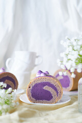 Swiss Roll Cake with sweet purple potato filling set on cafe table.
