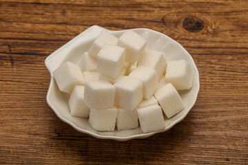 Refined white sugar cubs in the bowl