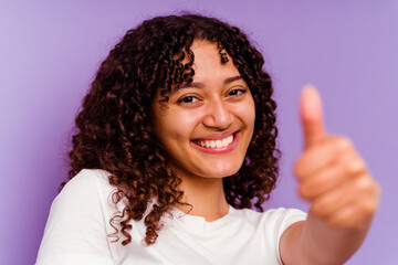 Young mixed race woman closeup isolated on purple background