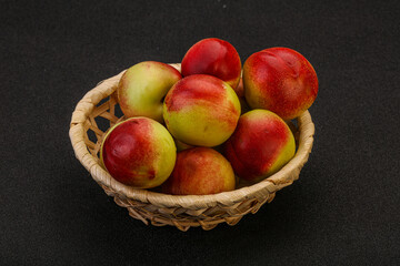 Sweet small nectarines in the basket