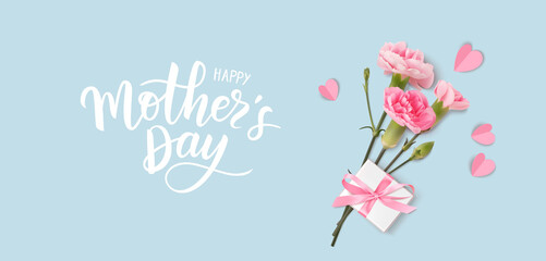 Happy Mothers day. Calligraphic greeting text. Holiday design template with realistic pink carnation flowers, gift box and paper hearts on blue background. Vector stock illustration.