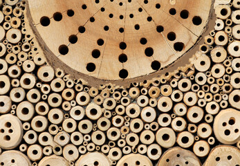 Insect hotel Bee hotel with small tubes in the wood