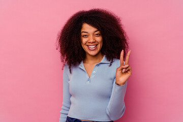 Young african american woman isolated on pink background showing number two with fingers.