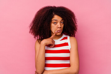 Young african american woman isolated on pink background unhappy looking in camera with sarcastic expression.