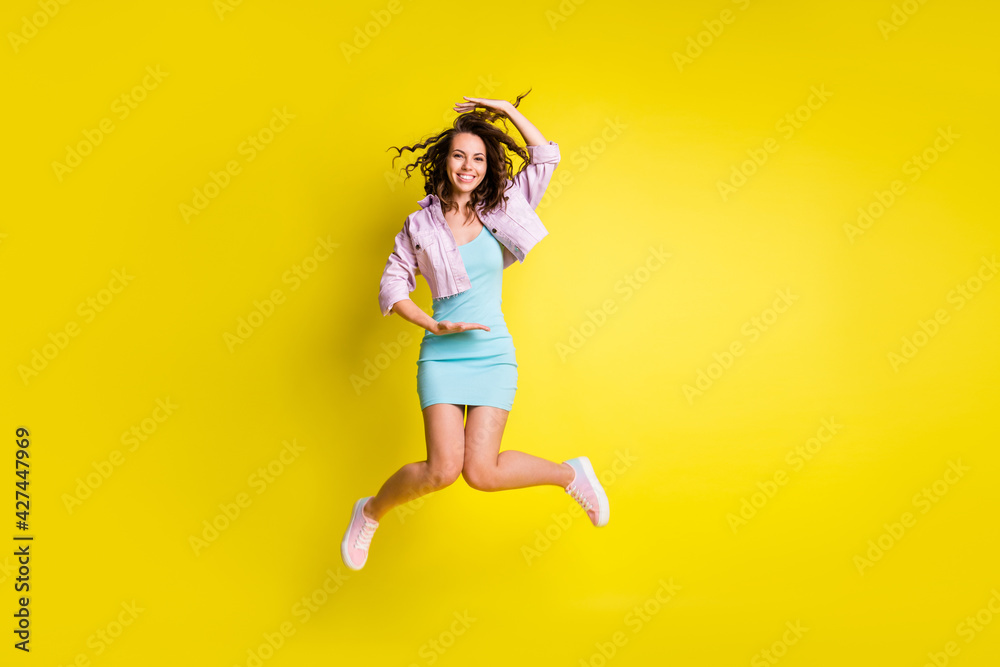 Sticker Full length body size view of pretty cheerful wavy-haired girl jumping showing large size isolated over bright yellow color background