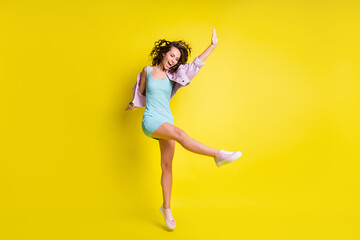 Fototapeta na wymiar Full size photo of happy excited funky funny girl dancing enjoying weekend free time isolated on yellow color background