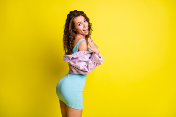 Rear portrait of funny carefree lady beaming smile look camera have good mood isolated on yellow...