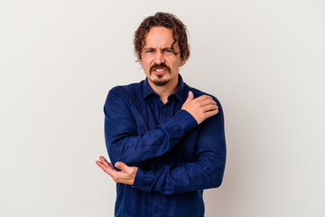 Young caucasian man isolated on white background massaging elbow, suffering after a bad movement.