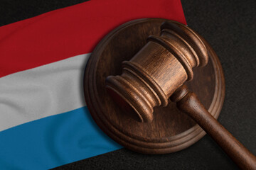 Judge gavel and flag of Luxembourg. Law and justice in Luxembourg. Violation of rights and freedoms