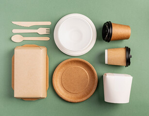 Eco friendly disposable tableware on green background