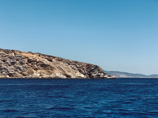Fototapeta na wymiar greek island hillside going into the Mediterranean Sea 