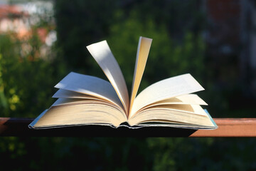 Open book in a garden. Selective focus.