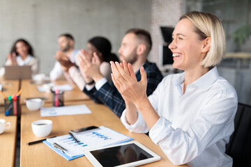 Happy Colleagues Applauding During Corporate Meeting Sitting In Modern Office