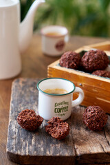 Chocolate coconut balls and coffee. Side view