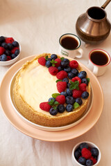 Cheesecake with berries on a white background. Side view.