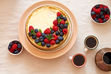 Cheesecake with berries on a white background. Top view.