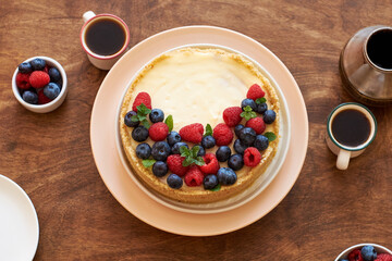 Cheesecake with berries on a wooden background. Top view.