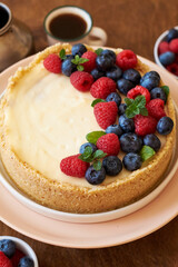 Cheesecake with berries on a wooden background. Side view.