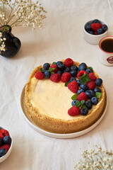 Cheesecake with berries on a white background. Side view.