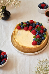 Cheesecake with berries on a white background. Side view.