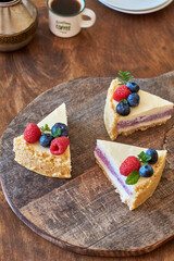 Cheesecake with berries on a wooden background. Side view.