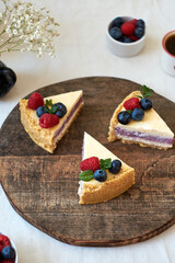 Cheesecake with berries on a white background. Side view.