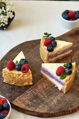 Cheesecake with berries on a white background. Side view.