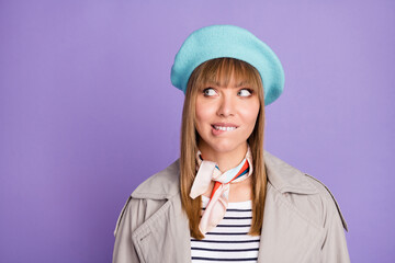 Photo of funny tricky lady bite lip look up empty space wear blue beret scarf coat isolated violet color background