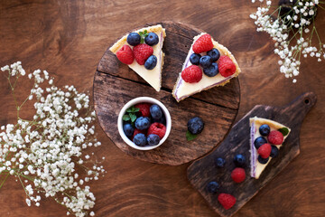 Cheesecake with berries on a wooden background. Top view.