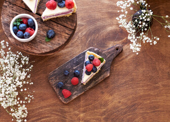 Cheesecake with berries on a wooden background. Top view.