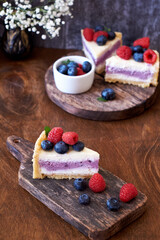 Cheesecake with berries on a wooden background. Side view.