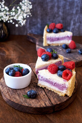 Cheesecake with berries on a wooden background. Side view.
